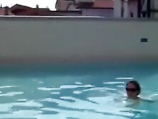 Topless cutie takes a swim