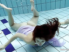 Floating Virgin Babe Swims And Strips Underwater