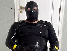 Rubber Man In Latex Catsuit And Penis Pump