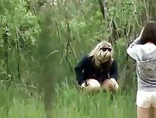 Woman And Friend Peeing Outdoors