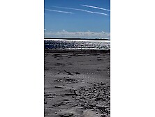 Hot MILF Natacha strips on the beach and then plays with herself