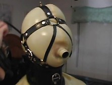 Latex loving mistress puts her maid in a hood