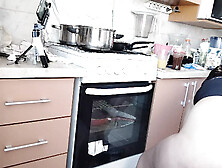 Sexy Latina nude in the kitchen. Sexy naked wife prepares food in the kitchen.