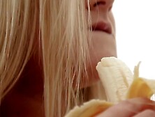 Beautiful curvy woman plays with a banana and bares her body