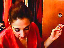 Hot cutie is smoking a cigarette in a sexy way