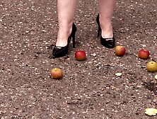 Crush fetish outdoors Plump legs in high heel shoes crush apples