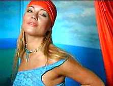 Bronzed dolly shows her breasts!