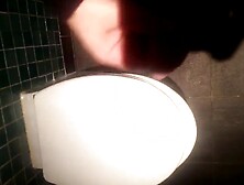 Wanking in a public toilet.