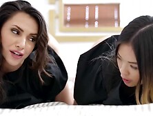 Two depraved girls are flirting with the camera while sharing cock