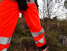 Worker In Hiviz Rain Gear And Rubber Boots