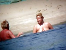 Mature woman showing her saggy tits and ass on beach