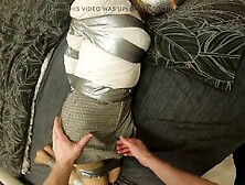 Bondage with silver tape in stockings and skirt