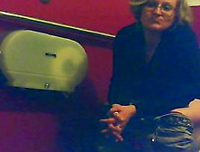 Mature Unsuspecting Female Sitting On A Toilet