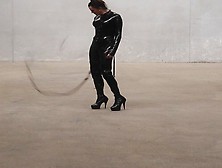 The Goddess Obsidian Wields Her Bullwhips Ominously In Her Latex Catsuit.