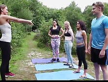 Girls And A Boy Do Yoga Outdoor