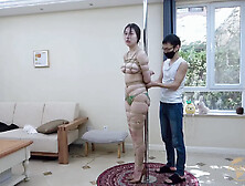 Tied to a pole with dildo gag