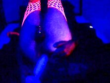 Caged Sissy plowed with a large glowing dildo in the dark light