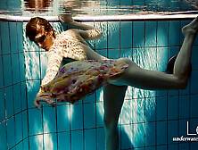 Floating babe in the swimming pool naked