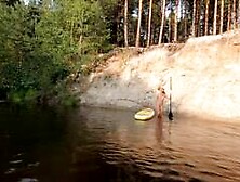 Tattooed Babe Strips and Swims on a SUP Board in the Forest River