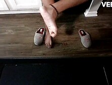 TINY GRAPES SQUISHED BY CHRISTMAS SLIPPERS AND TOES