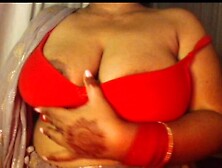 She shows her boobs by taking off her bra.