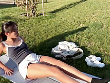 Horny babe plays with sex toy in public park