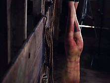 Slave is hung upside down and whipped hard