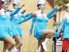 Hot young majorettes in blue flash their sexy legs as they