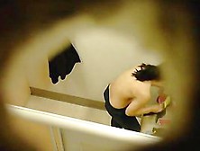 This cute babe is spotted in a changing room with naked boobs