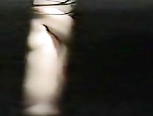 One hot naked tit spied through hole between window curtains