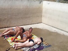 Three Caught Topless Sunbathing