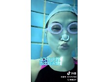 Asian Girl Holding Breath Underwater