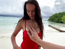 Wet oral pleasure from a breasty brunette hair on a desert island