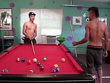 Jorge and Tiger are having a friendly game of billiards in the rec room