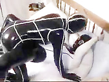 Cute college girl making out in latex catsuits