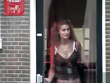 Amsterdam prostitutes tease in the windows