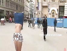 Curly sexy brunette on high heels and with very short skirt serv