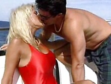 Busty lifeguard having fun on a boat