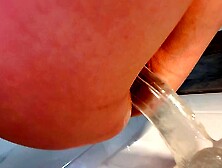 A petite girl fucks herself to orgasm in the bathroom