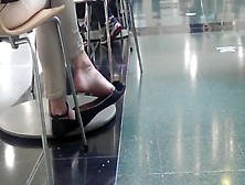 Voyeur filming gorgeous babe dangling her candid feet in public