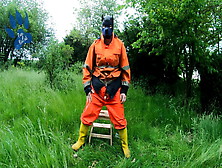 Riding Dino Toy In Garden Wearing Hivis And Rubber Boots