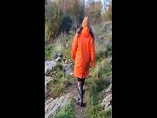 Taking A Stroll In Orange Raincoat And Rubber Boots