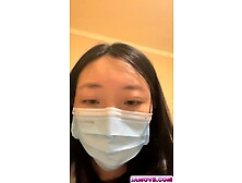 An Asian woman is seen urinating on in a public washroom