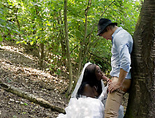 Black bride and a white groom are having sex in the woods