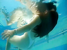 GF in white swimsuit underwater
