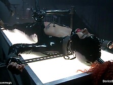 Chained black wench Daisy Ducati on illuminating table clothed in latex gets whipped then in other device slavery poses takes co