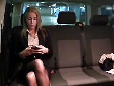Taxi driver takes care of bored blonde girl in the backseat