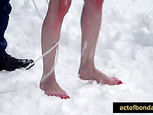 Readhead hotty completely bare and fastened up in the snow.  Barefoot stripped servitude