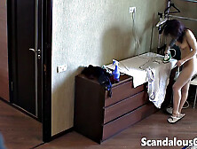 Nude tattooed brunette ironing clothes in the house