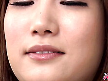 Thai woman Mikuni Maisaki likes to tease herself on the couch with a sex toy.